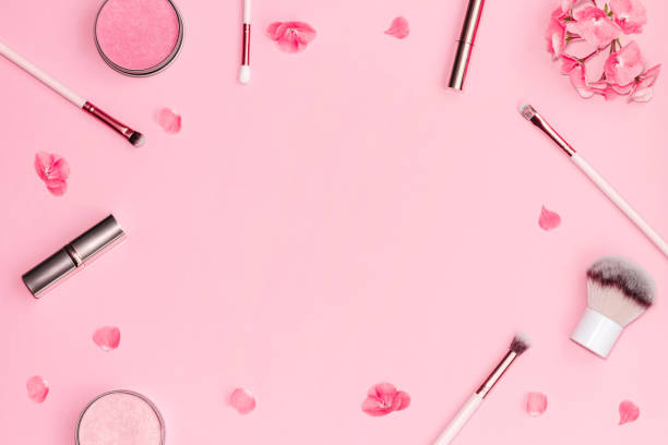 istock Flat lay composition with decorative makeup products and pink flowers on pastel pink background. 1143083299