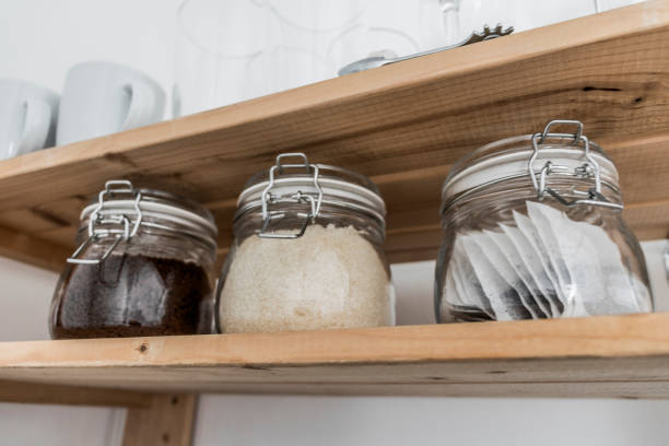 istock Tea, coffee and sugar in preserving jars on wooden shelf. 1143084130