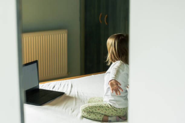 istock Little girl using laptop in home 1143084927