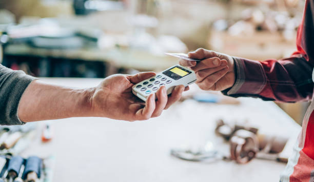 istock Man at wood workshop paying contactless with credit card 1143085279