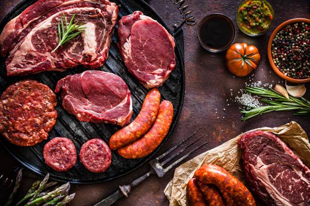 istock Various cuts of raw meat shot from above on a cast iron grill 1143085899