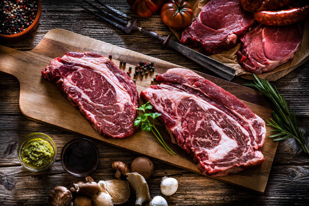 istock Top view of two raw beef steaks on cutting board 1143085947