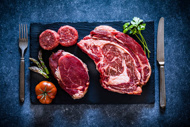 istock Various cuts of raw meat shot from above on slate board 1143086134