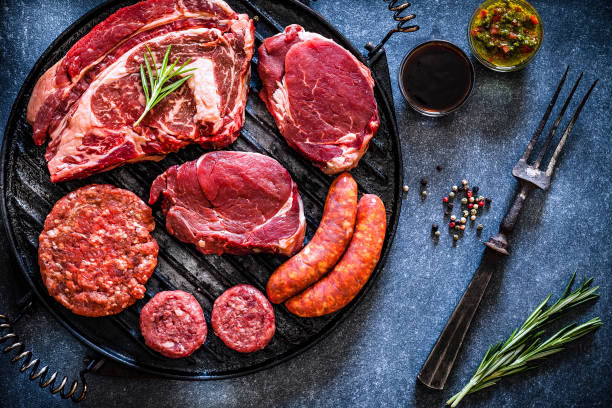 istock Various cuts of raw meat shot from above on a cast iron grill 1143086161