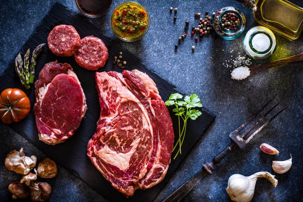 istock Various cuts of raw meat shot from above on slate board 1143086163
