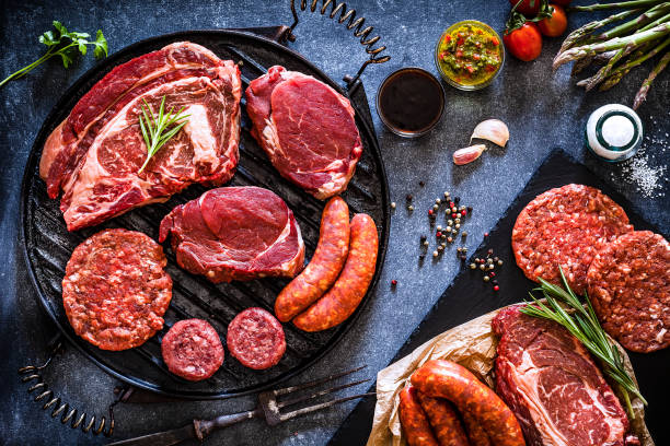 istock Various cuts of raw meat shot from above on a cast iron grill 1143086168