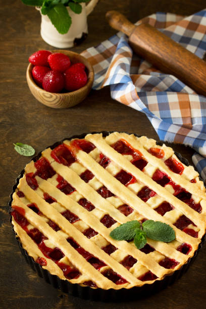 istock Berry pie summer. Sweet pie, tart with fresh berry strawberries on a rustic kitchen table. Delicious cake with strawberries. 1143086807