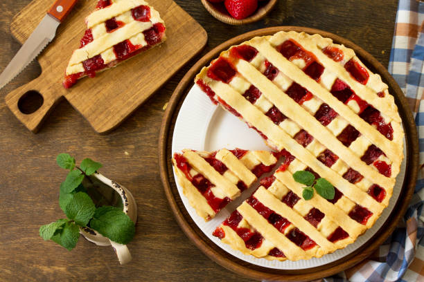 istock Berry pie summer. Sweet pie, tart with fresh berry strawberries on a rustic kitchen table. Delicious cake with strawberries. Top view flat lay background. 1143086814