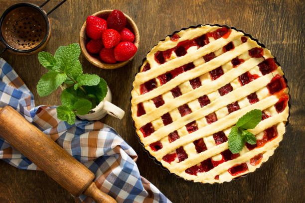 istock Berry pie summer. Sweet pie, tart with fresh berry strawberries on a rustic kitchen table. Delicious cake with strawberries. Top view flat lay background. 1143086818