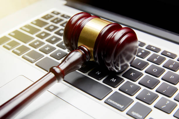 gavel on computer keyboard - sleaze stock-fotos und bilder