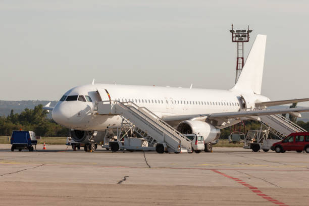 istock Airplane is serviced by the ground crew. Airplane getting prepared for take off 1143089099