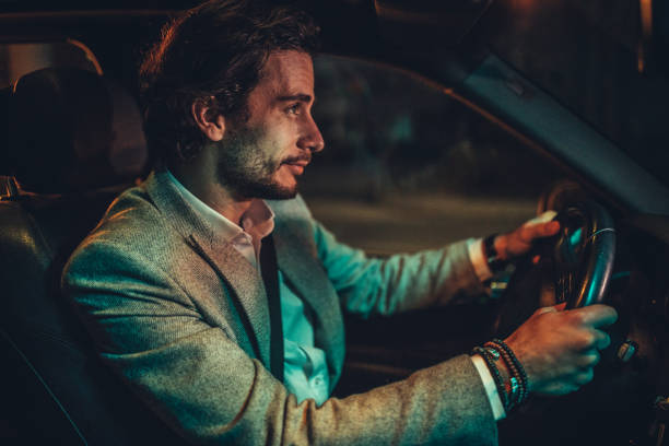 istock Businessman Driving A Car In Night 1143090013