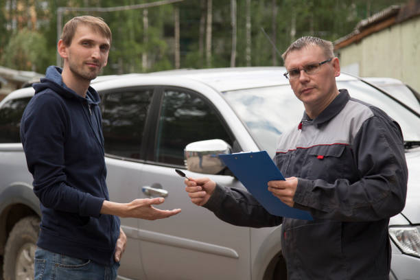 istock Mechanic delivers a repaired car to the client. 1143090368