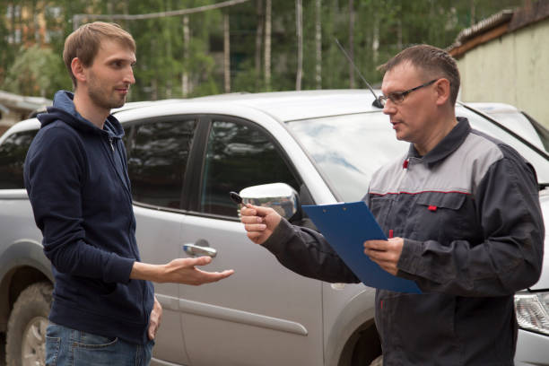 istock Mechanic delivers a repaired car to the client. 1143090389
