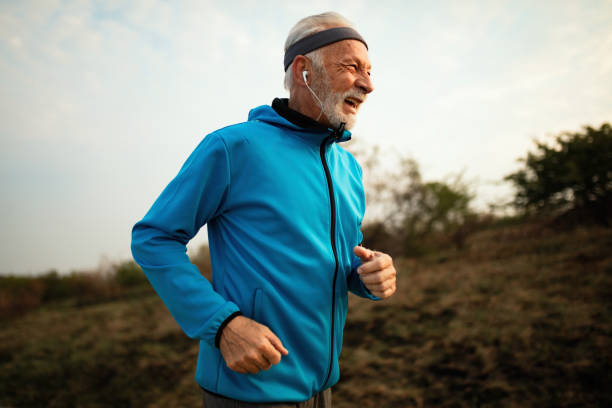 istock Cheerful mature athletic man running in nature. 1143091865