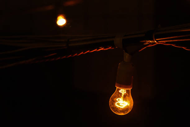 istock Burning in the dark, a light bulb, an orange light bulb 1143092886