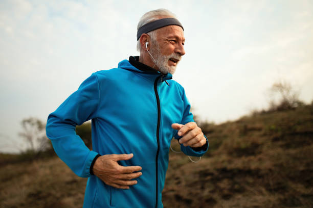istock Mature male runner jogging in nature. 1143093705