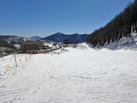 Roccaraso, L'Aquila, Abruzzo, Italy - March 15, 2019: Blue track of the Macchione ski resort, on the Aremogna