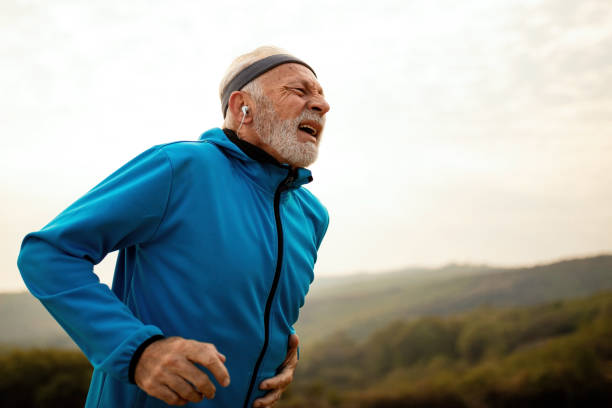 istock Exhausted senior runner feeling pain while jogging in nature. 1143096487