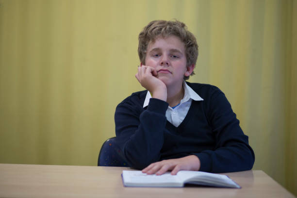istock Schoolboy sitting at his Desk. 1143096814