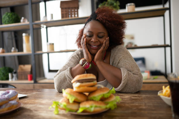 istock Joyful curly haired housewife looking at sandwiches 1143096863