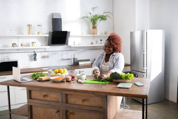 istock Positive delighted woman cutting greenery for salad 1143096945