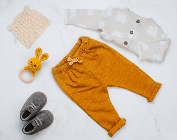 istock Baby clothing, booties and teether on light marble background 1143098265