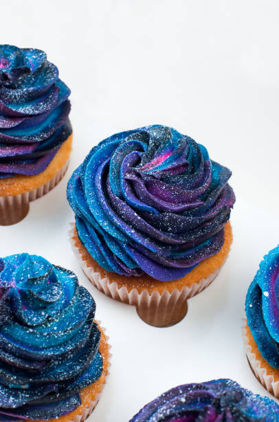 istock Box with vanilla cupcakes with galaxy dark whipped cream 1143099150