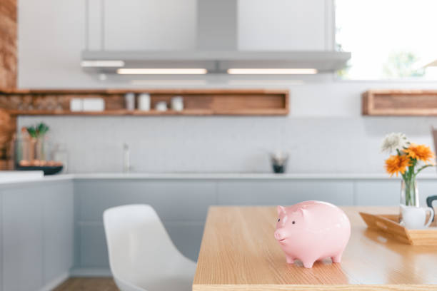 Piggy Bank On The Kitchen Counter - Home Finances Piggy bank on the kitchen counter. Kitchen and home economy. animal representation photos stock pictures, royalty-free photos & images