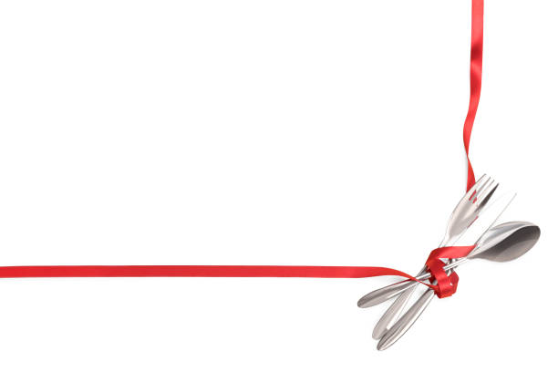istock Fork, spoon and knife tied with a red ribbon isolated with copy space 1143099872