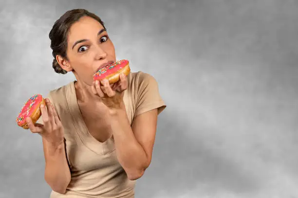 Photo of Woman eating a huge donut