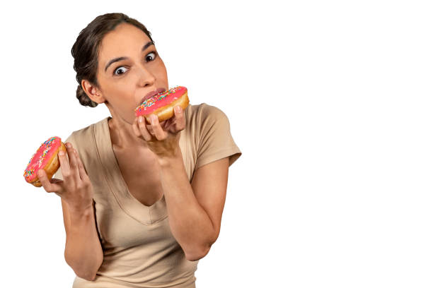 istock Woman eating a huge donut 1143100198