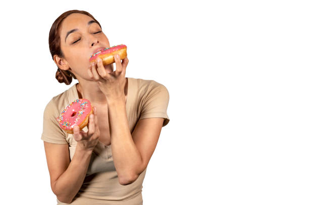 istock Woman eating a huge donut 1143100775