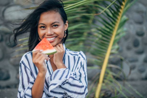 istock Pretty Asian woman eating watermelon 1143101346