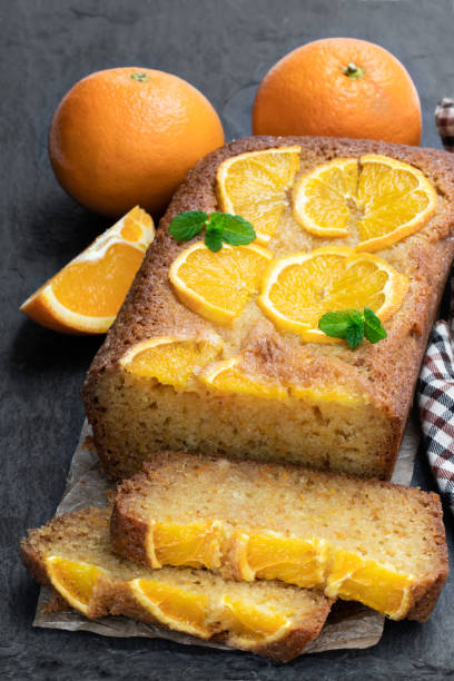 istock Homemade orange syrup cake on black stone background 1143101773