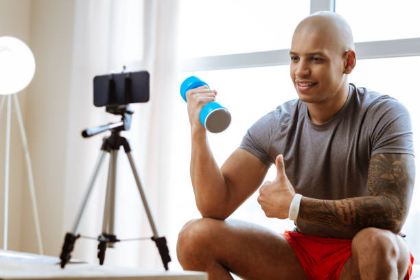 istock Bald bodybuilder recommending best exercises with dumbbells 1143103396