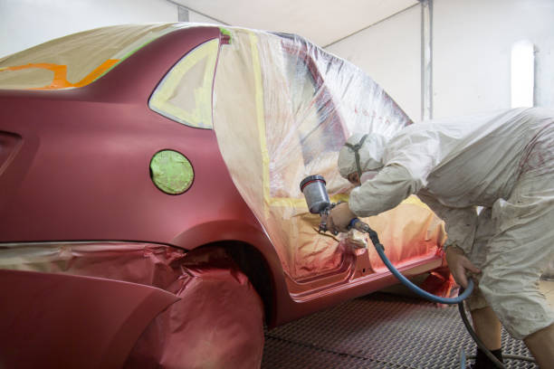 istock Mechanic repairs and paints the car. 1143104751