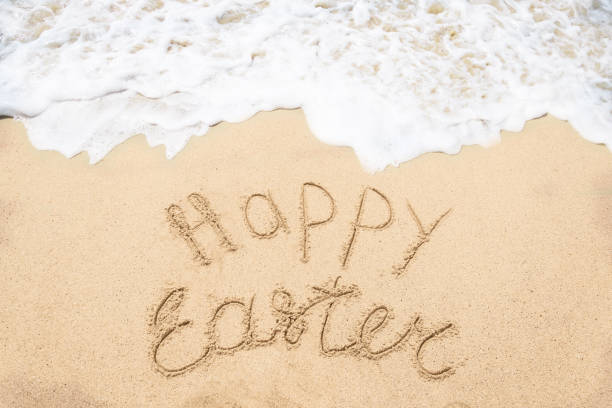 istock Happy easter lettering background on the sandy beach 1143104943