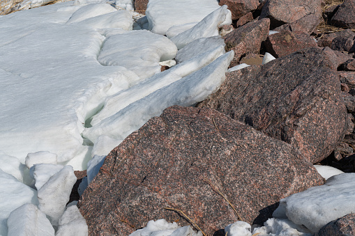 beautiful broken ice background and granite stone top view. the texture of the ice and rock
