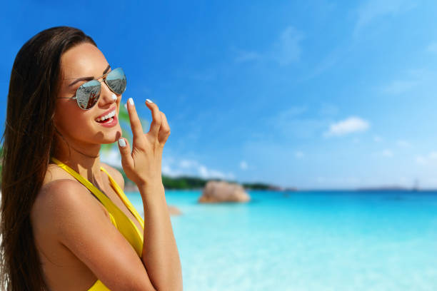 istock Beautiful bikini model smiling at the tropical beach with ocean background 1143106138