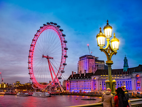 London, UK - February 12, 2019: Romantic scene of the famous Millennium Wheel of London, the big Eye in evening lights, in United Kingdom