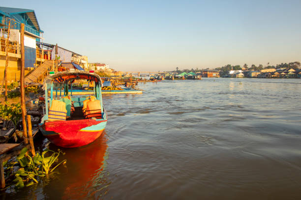 Boats and houses of Chau Doc in Vietnam_ stock photo