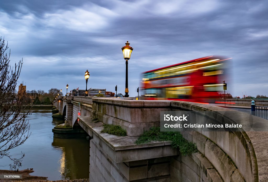 Putney bridge Putney bridge early in the morning at twilight and public transport by traditional red double decker  bus in motion in London, UK Putney Stock Photo