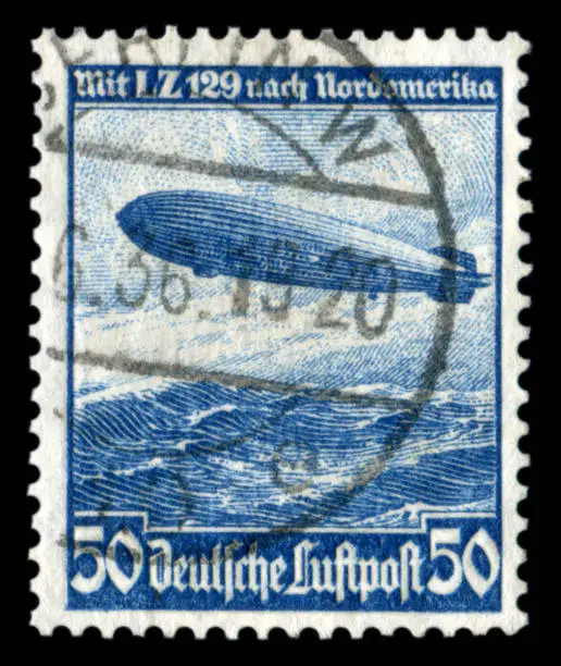 GERMANY - CIRCA 1936: German historical stamp:  mesatlantica flights L. Z. 129 (airship "Hindenburg") over the Atlantic ocean with cancellation, DR, third Reich
