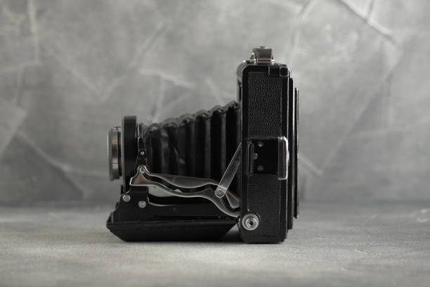 istock The old Large format film camera on grey cement background. 1143114966