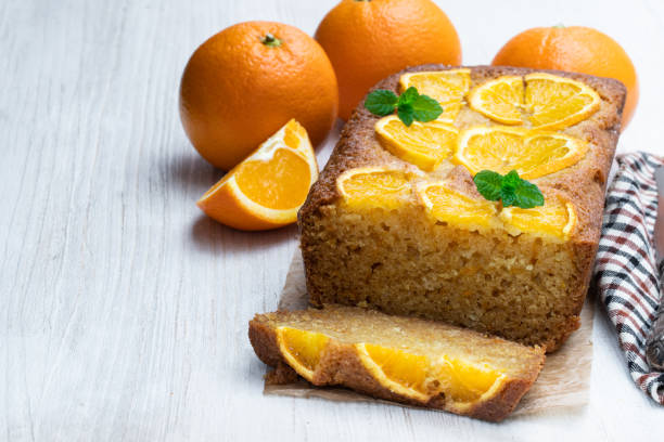 istock Homemade orange syrup cake on white wooden table 1143115886