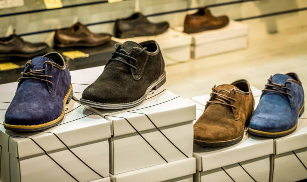istock Men's shoes in different colors (blue, brown) standing on the boxes 1143118142