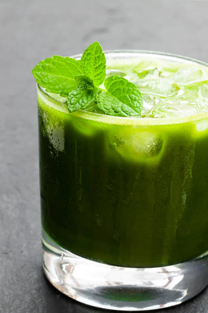 istock Homemade iced matcha latte tea on black stone background 1143119719