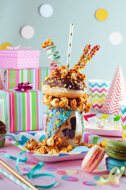 istock Chocolate freak shake topping with donut and caramel popcorn on the party table 1143121923