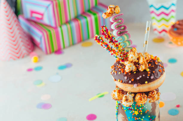 istock Chocolate freak shake topping with donut and caramel popcorn on the party table 1143121962